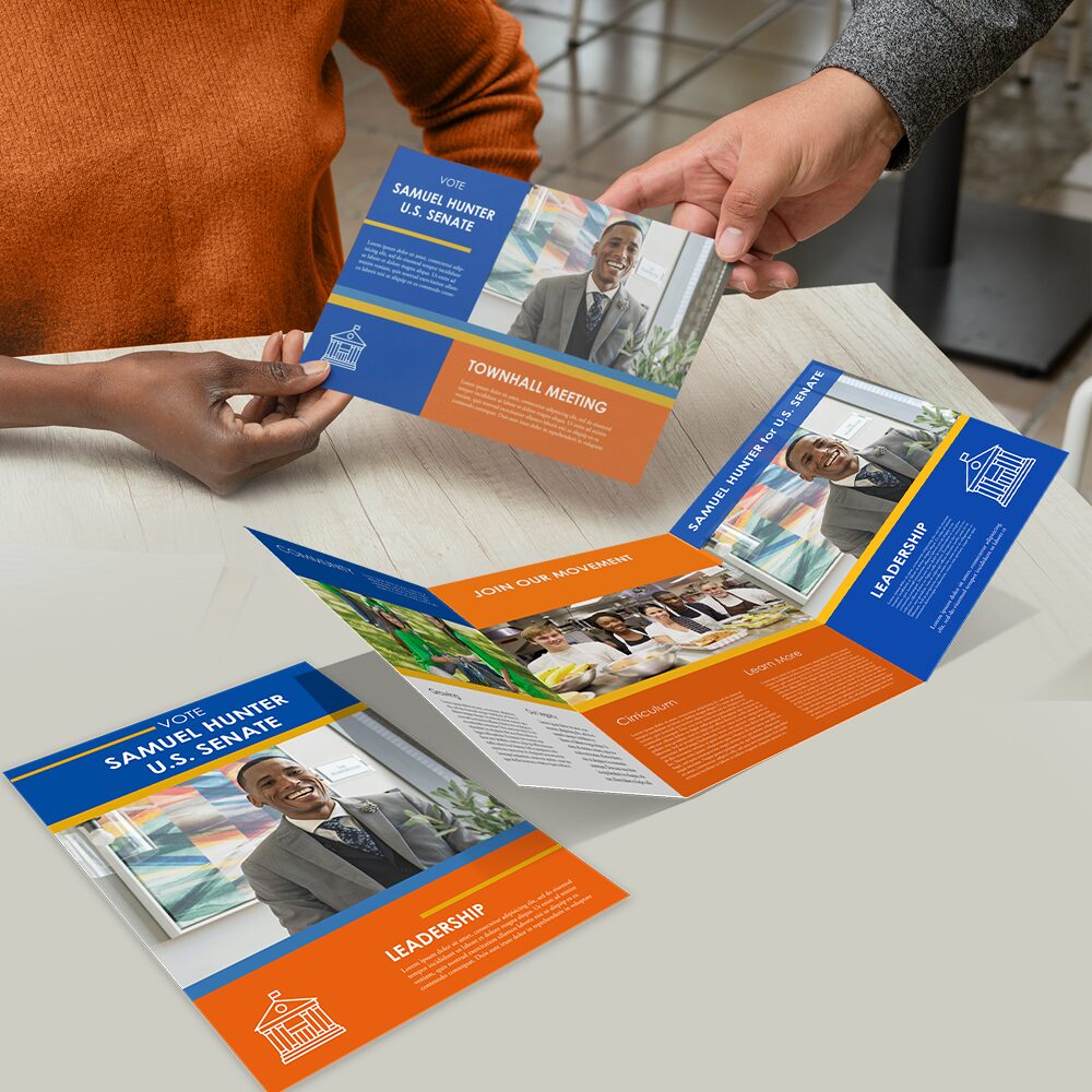 Print brochures on a table being handed out and on display